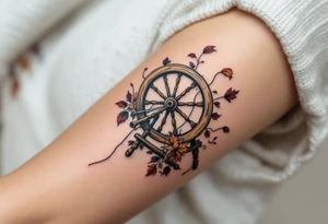 A tattoo of an old spinning wheel in motion, with threads flying, made of aged elm wood, paired with autumn-colored yarn scraps caught mid-air. tattoo idea