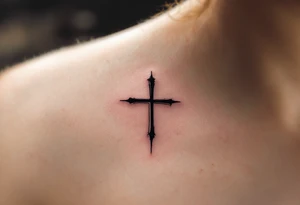 A small, sharp-edged black cross tattoo placed just beneath the outer corner of the eye, with subtle red shading around the lines to give it a raw, rebellious aura. tattoo idea