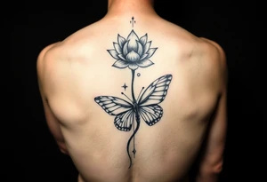 Elegant spine tattoo with lotus flower and butterfly with cracked wings mid back down tattoo idea