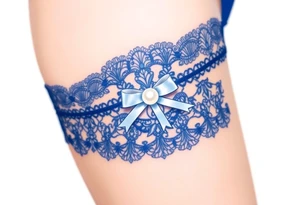 A delicate lace garter tattoo in deep royal blue, adorned with a small white satin bow and pearl centerpiece tattoo idea