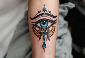 A blue and bronze Eye of Horus, detailed with ancient lines, placed on the forearm for protection and healing. tattoo idea