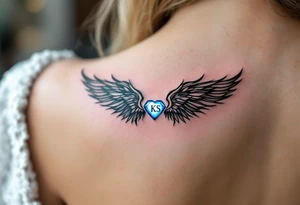 A pair of black ink wings cradling a small, glowing blue gem with the son’s initials KS inside. tattoo idea