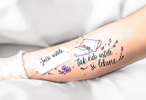 "Jak si kdo ustele, tak si lehne." — A cozy bed drawn in fine black linework, surrounded by delicate lavender accents and the quote on a pillow tag. tattoo idea
