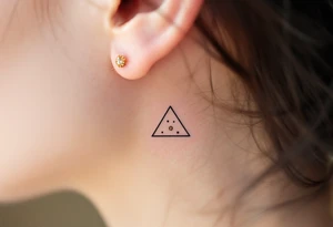 Three gold ink dots placed behind the ear in a triangle, inspired by celestial navigation and guidance. tattoo idea