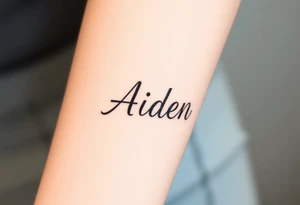The name Aiden chunky
 and bold cursive tattoo idea