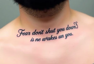 "Fear doesn’t shut you down, it wakes you up" engraved in an elegant script, surrounded by subtle abstract smoke tattoo idea