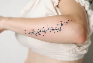 The Pisces constellation is dotted with tiny aquamarine stars that flow like water along the spine. tattoo idea