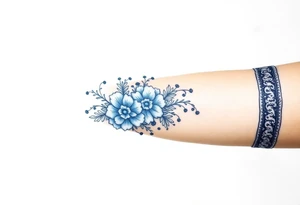 forearm porcelain blue style with ornate and floral decor with a detailed banded border at the wrist and elbow. tattoo idea