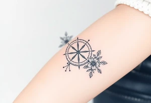 Compass with cursive letters with dot work flowers flowing above and below the compass tattoo idea