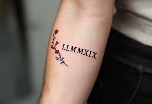 I.I.MMXIX written in pure black ink along the forearm with red rose vines delicately wrapping around. tattoo idea