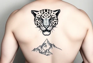 Jaguar face in the back of the arm close to elbow mountains at the bottom close to the wrist tattoo idea