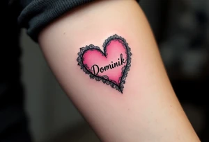 A solid pink heart with lace-like details and the name Dominik in script. tattoo idea