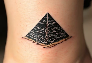 A jet-black pyramid casting a shadow over a golden sand dune. tattoo idea