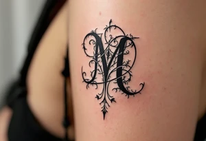 A bold blackletter-style "M" in deep onyx black with sharp gothic edges. tattoo idea