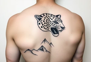 Jaguar face in the back of the arm close to elbow mountains at the bottom close to the wrist tattoo idea