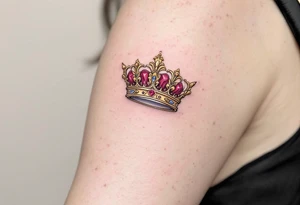 Baroque-style crown designs with gold and ruby detailing, sitting atop script names. tattoo idea