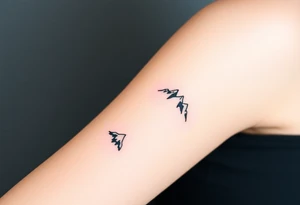 A pair of minimalist black and blue mountain peaks, one tattooed on the one´s forearm and the matching smaller version on the cother tattoo idea