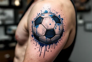 A dripping-ink soccer ball in grayscale with splashes of cobalt blue for contrast. tattoo idea