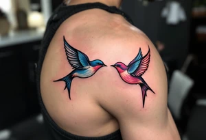 Stylized swallows in dusty rose and deep blue flying toward each other on the back shoulders signify freedom and loyalty. tattoo idea