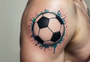 A small behind-the-ear soccer ball tattoo in black with a splash of teal paint. tattoo idea