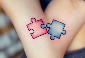 Interlocking puzzle pieces in soft pink and muted blue on the inner wrists symbolize how perfectly you fit together. tattoo idea