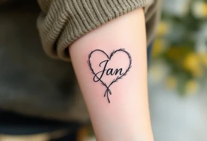 A delicate, outline heart with a flowing ribbon, containing the name "Jan" in elegant cursive, with soft pastel pink and gold accents. tattoo idea