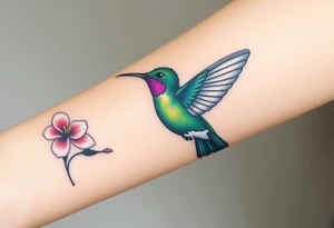 A hummingbird in iridescent green and blue shades, hovering near a blossoming flower, embodying endurance and positivity tattoo idea