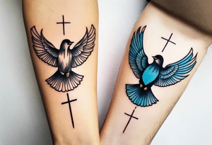 Two birds on forearm flying towards each other one below the other and up towards with a cross in between them tattoo idea