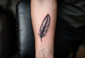 A single soft grey feather drifting down the forearm, capturing the lightness of freedom. tattoo idea