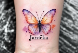 Janička name framed by a soft watercolor butterfly, in shades of peach and lavender. tattoo idea