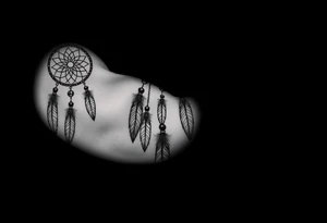 native dreamcatcher with flowing feathers and sacred beads tattoo idea