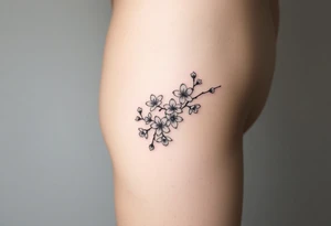 Feminine cherry blossoms thigh tattoo idea