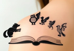 An open book with black silhouettes of a werewolf, an owl, a dragon & a phoenix coming out of the book tattoo idea
