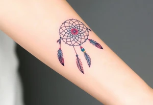 native dreamcatcher with flowing feathers and sacred beads tattoo idea