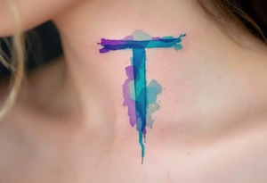 A watercolor-style "T" in shades of turquoise and purple, blending like paint strokes. tattoo idea