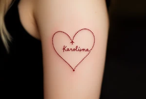 A dotted-line heart in red ink with a tiny plane drawing a trail spelling Karolína. tattoo idea