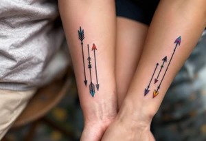 Tribal-style arrows in black with colored tips on the forearms on each partners point toward your shared journey. tattoo idea
