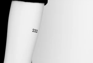 A sleek, minimalist barcode with the couple’s wedding date (22 - 12 - 2012) hidden in the numbers, symbolizing a love marked in time tattoo idea