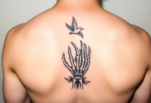 Skeleton hand reaching out of the ocean for a flying swallow in the Sailor Jerry style tattoo idea