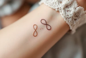 Three infinity symbols in gold, silver, and rose gold, each person (three) has its own tattoo idea