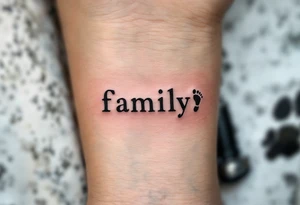 The word family beneath a row of tiny matching footprints in soft earth tones. tattoo idea