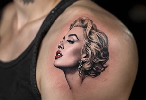 A side-profile portrait of Marilyn in faded black ink with soft blush undertones and golden highlights in her hair. tattoo idea