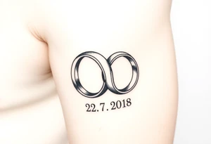 two wedding rings with date 22. 7. 2018 tattoo idea