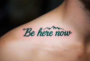“Be here now” in deep forest green sans serif, with mountain outlines in cool slate. tattoo idea