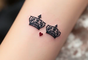 Ornate filigree-style black crowns with small deep red heart designs beneath each. tattoo idea