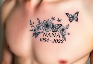 memorial tattoo with flowers and butterflies with the name “NANA” and the date “1954-2022” mixed all together on the side of the rib cage tattoo idea