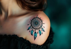 A turquoise dreamcatcher symbol with feathers and protective glyphs woven into the web tattoo idea