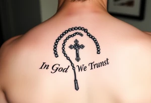 Rosary surrounded by the words "In God We Trust" tattoo idea