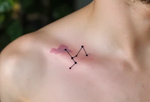 A soft pastel rendering of the Capricorn constellation on the collarbone, with pink and lavender clouds behind it. tattoo idea