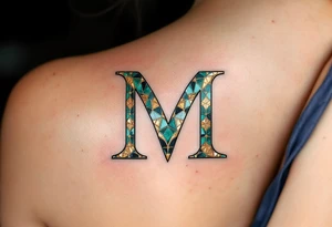 A mosaic-style "M" made of gold and emerald tiles, creating a royal effect. tattoo idea